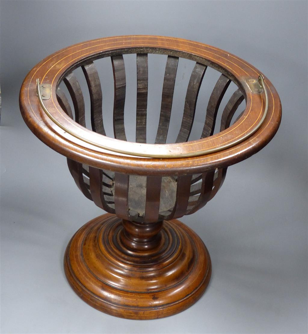 An early 20th century Dutch walnut jardiniere, lacking brass liner